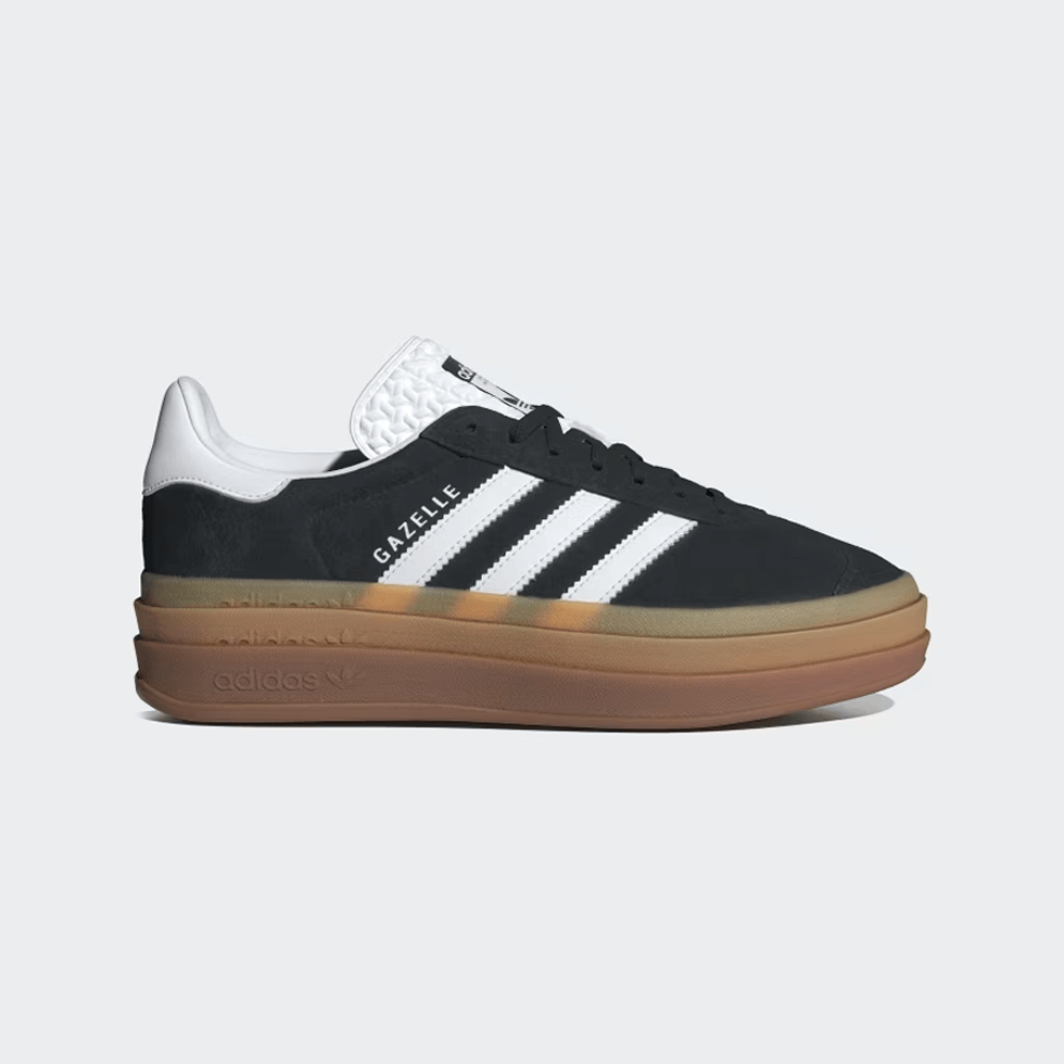 Celebrity approved for Fall 2024: Black adidas Gazelle Bold sneakers with white stripes.