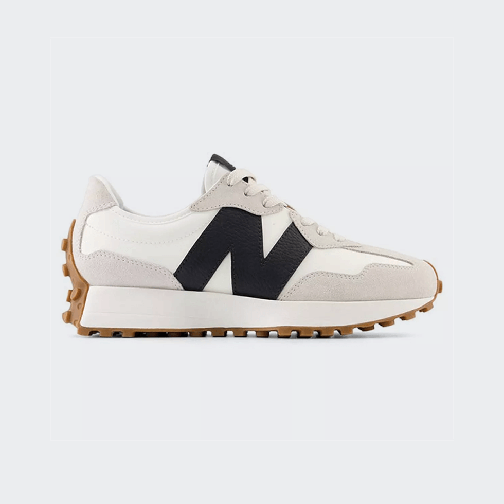 Beige and cream neutral New Balance 327 sneakers with black logo - a top sneaker pick in 2024.