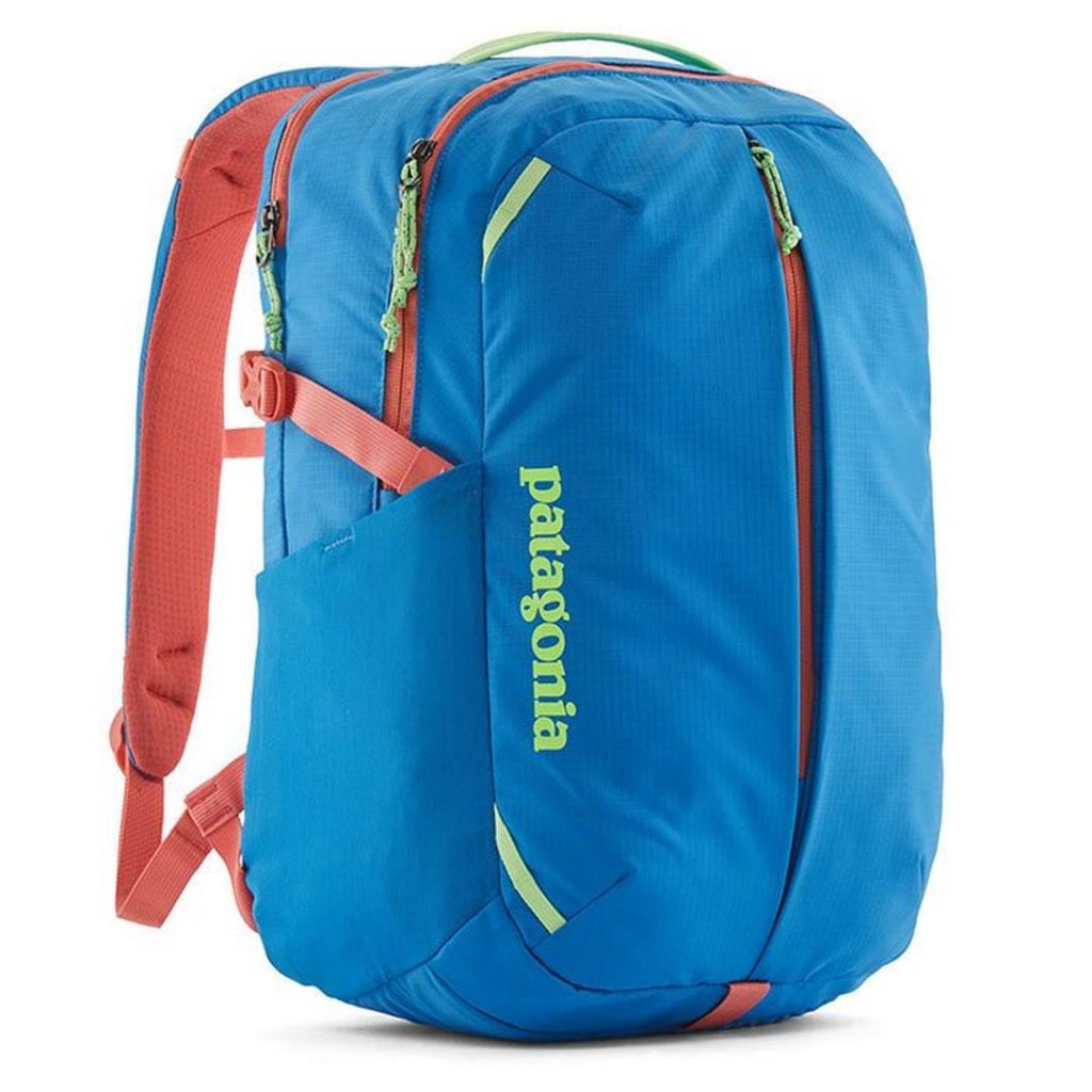 blue backpack with contrast orange trim at the zippers and shoulder straps; contrast neon green details at the top carry handle and zipper pulls, as well as a neon green "PATAGONIA" wordmark branding at the backpack's front-left; two large zip main copmartments and a zipper down the centre front