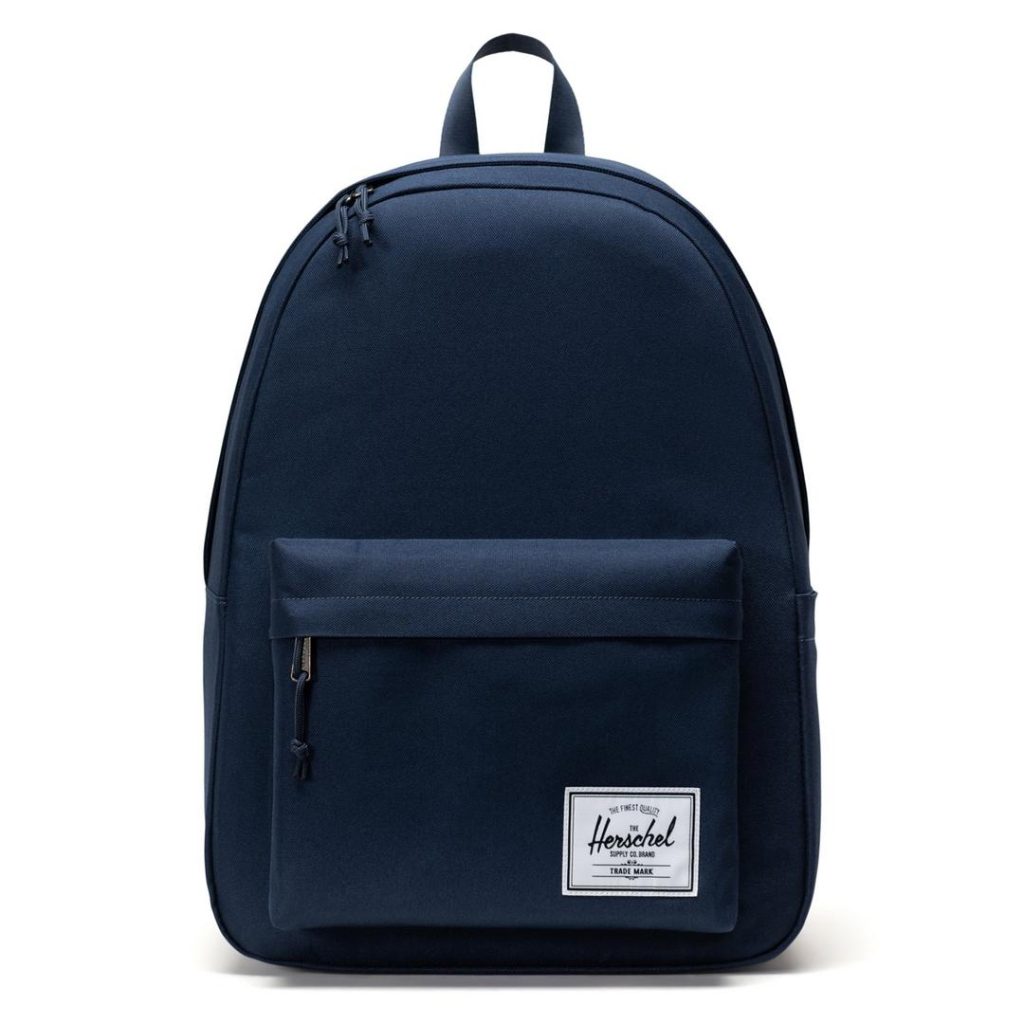 midnight blue/navy rounded top backpack with two-way zippers at the main compartment, a top loop carry handle and a lower-front zip pocket with a contrast white Herschel logo patch