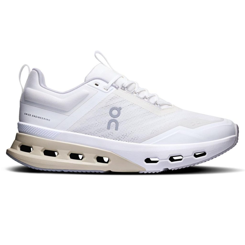 Sporty white On running shoe with tonal details. Neutral colour along the back half of the rubber outsole, white laces on the top, white pull loops at the heel and tongue. Rectangular cutout details along the sole (4 at the back and 3 towards the forefoot). Light grey On logo branding at the side.