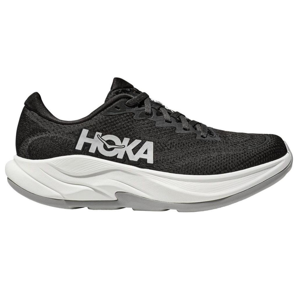 Sporty low-profile black and white HOKA running shoe with a black mesh upper and a thick white foam outsole. Black laces on the top. Contrast white HOKA wordmark branding at the side.