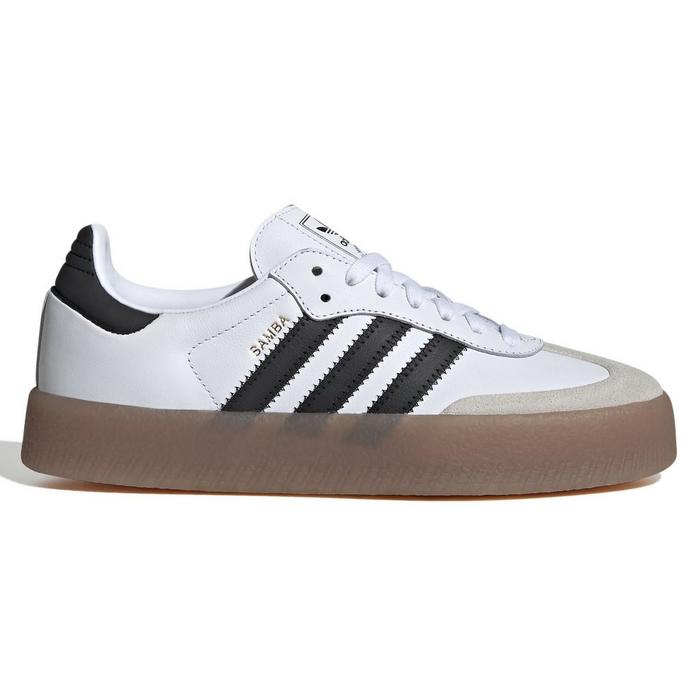 Low-profile white leather adidas sneaker with contrast black 3-Stripes at the side and a contrast black heel tab at the back. Tonal light grey, neutral suede t-toe. White laces on the top. Thick contrast brown gum rubber platform outsole. 2025 best school shoes