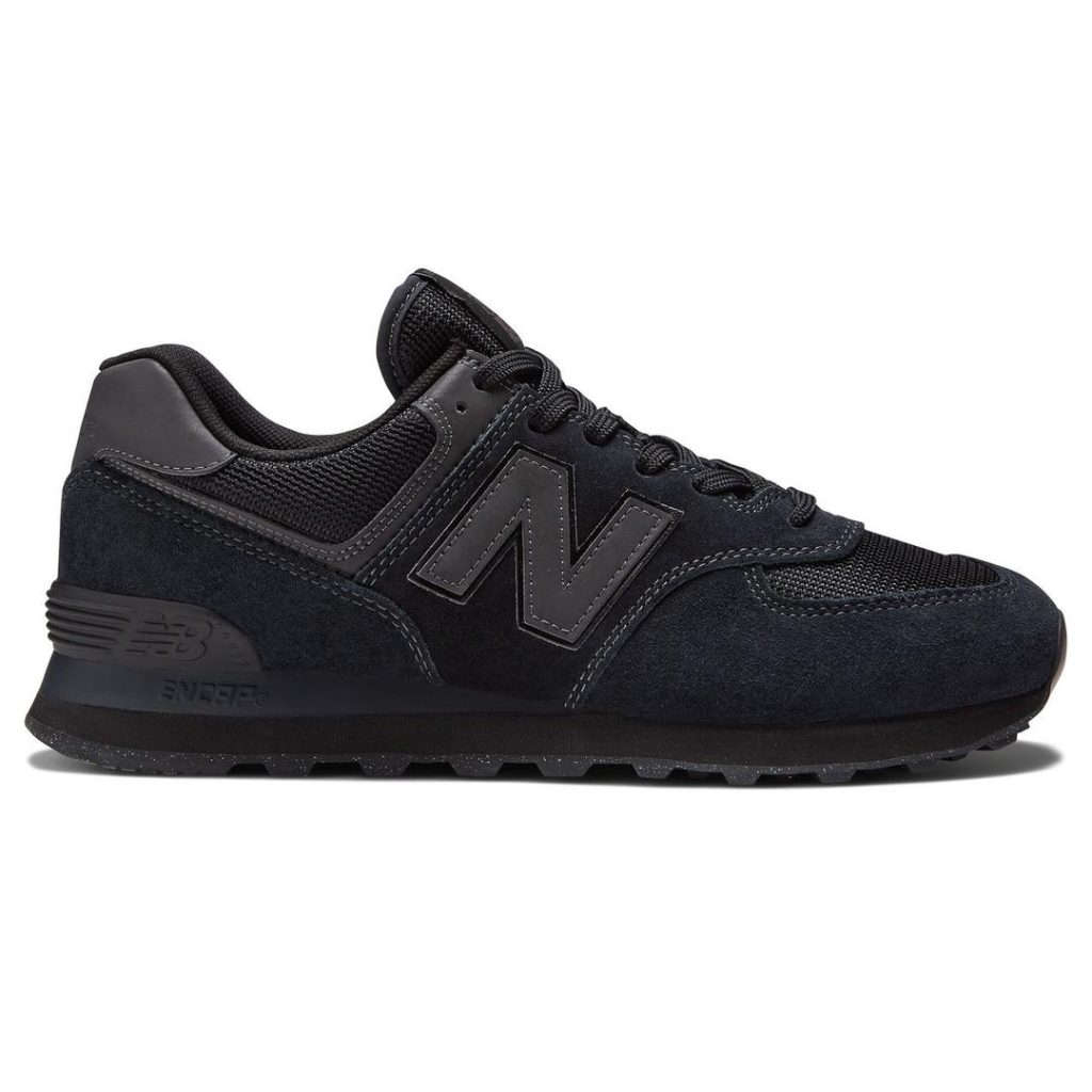 All black low-top New Balance sneaker with a slightly chunky profile. Tonal black details with contrast black trim at the heel panel and "N" letter logo at the side. Black laces at the top. 2025 best school shoes