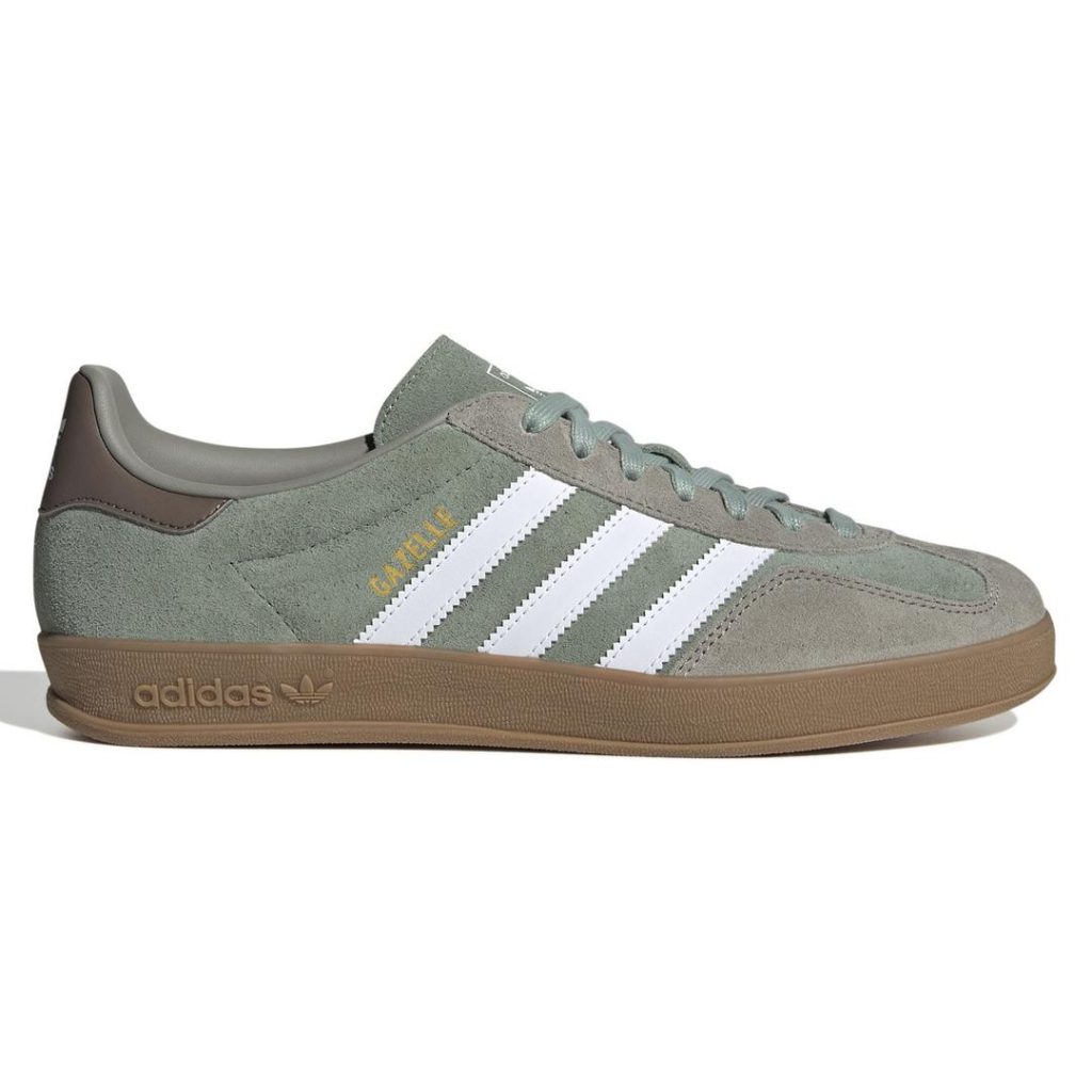 Low-profile pale olive green suede adidas sneaker with contrast smooth dark brown heel panel and white 3-Stripes detail at the side foot. Tonal pale olive green laces at the top and a pale olive green tongue. Brown gum rubber outsole with debossed adidas wordmark and Trefoil logo.